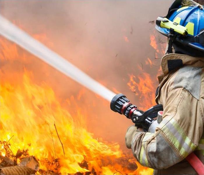 Fire fighters attempt to quench the flames of a roaring inferno